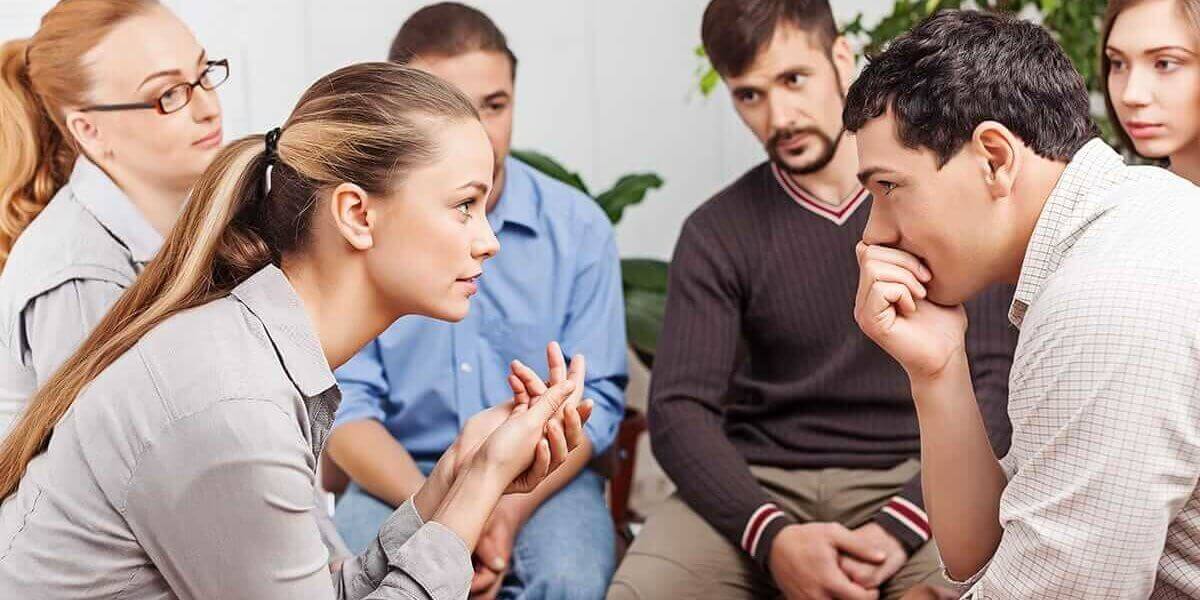 Group therapy session during a 12 step addiction recovery program