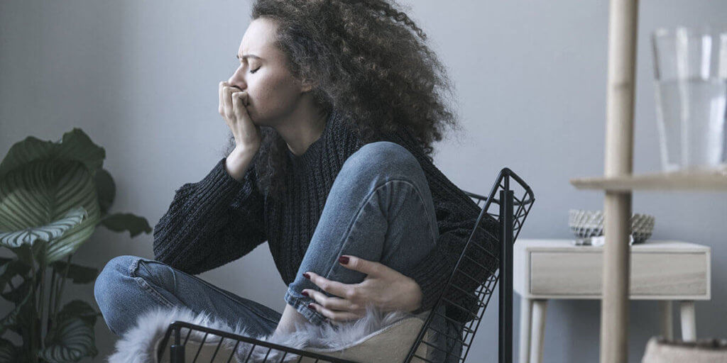 Teenager with depression sitting alone