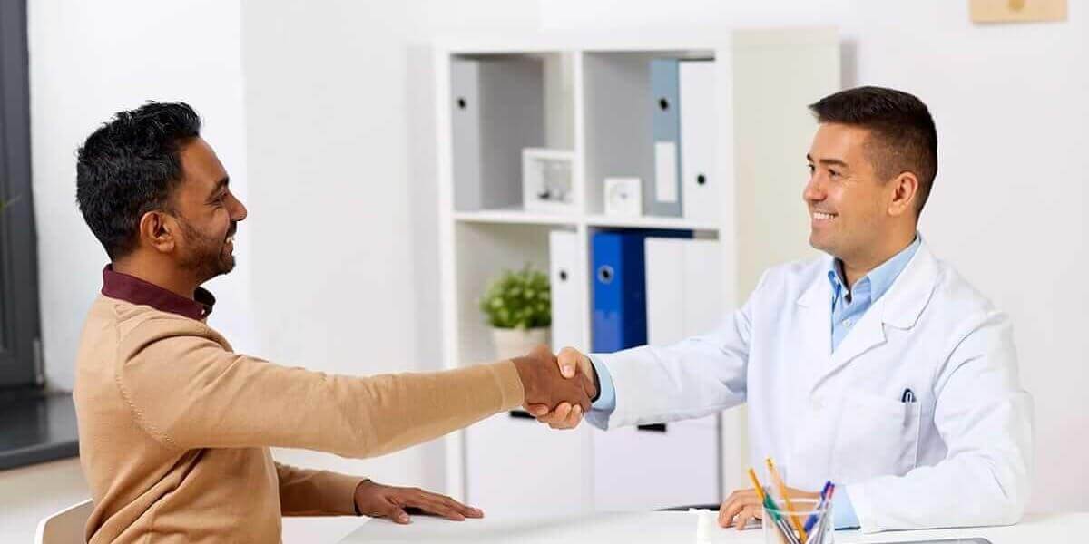 man shakes doctor's hand after he learns about humana drug rehab coverage.