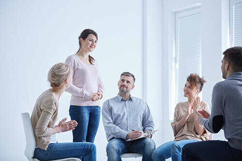 Woman speaking at a group therapy program in Denver CO