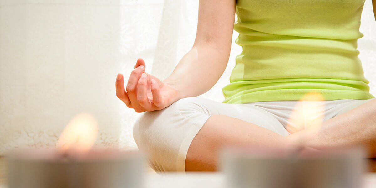 woman practices meditation at a holistic drug rehab center