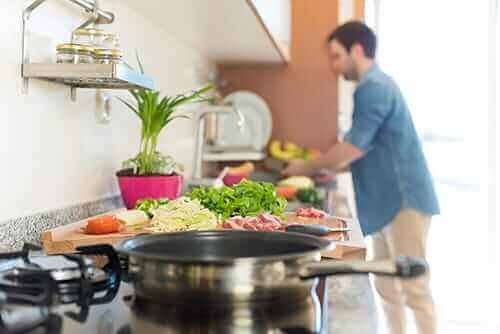 a man learns to cook as part of his life skills training program