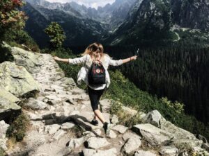 Woman hiking happily in the mountains